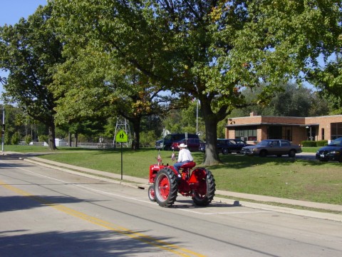 Edwardsville, IL: Tractor going down the road in front of the elementary school