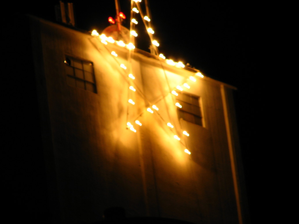 Monroe City, MO: The star shining atop the 160 foot tall Farmers Elevator & Exchange Co. grain elevator
