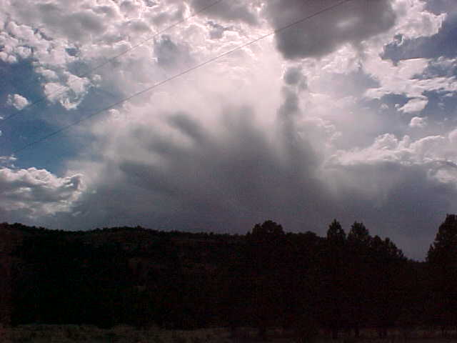 Ramah, NM : Clouds in the shape of a hand over cliffs by Ramah Lake