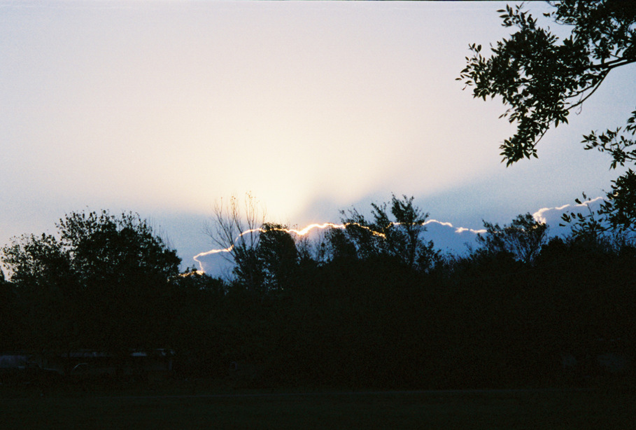 Heavener, OK : The sun just cresting the trees and Runestone from our back door