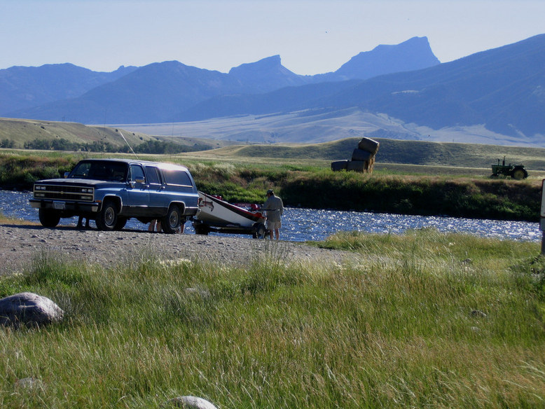 Ennis, MT: Early morning fly fisherman preparing for a float from Macatee bridge on the Madison River