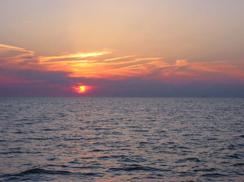 Muskegon, MI: Orange sunset over lake Michigan