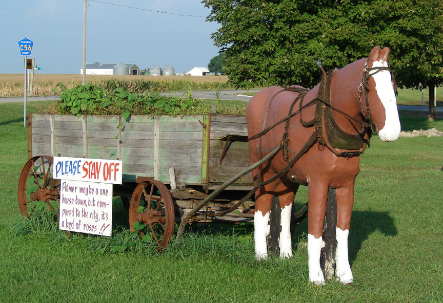 Palmer, IA: Palmer may be just a spot on the map to some folk, but this tiny berg is the proud keeper a life-sized horse statue that forever stands in front of a for-real wooden wagon... which is something than those know-it-all smarties in New York city will never own.