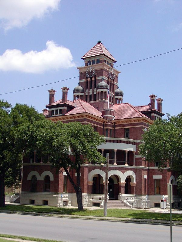 Gonzales, TX: The (red brick Romanesque Revival style) Gonzales County Courthouse was built in 1887