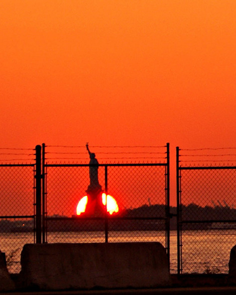 Brooklyn, NY: Statue Of Liberty at sunset from Brooklyn DUMBO ... near the water taxi stop and River Cafe.
