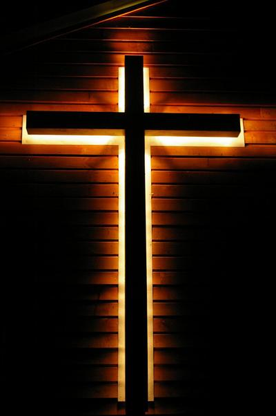 Woodsville, NH: Illuminated Cross shining through the darkness to light the way in these troubled times.