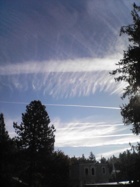 Nevada City, CA : Very Strange Clouds formed by persistant contrails of high flying jet aircraft above the down town area of Nevada City, CA 2007 - possible trial of weather manipulation technology?