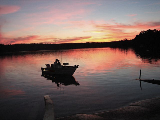 Lee, MA : Evening fisherman coming into boat ramp at Laurel lake, Lee