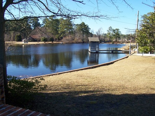 Springdale, SC: A view looking north from Durham Road at the pond of the Shadblow Subdivision in Springdale, South Carolina. The name of this pond, formed by damming Sixmile Creek, might be "Shadblow Community Pond", or it might not. An eight foot aligator was removed from the pond in 2007. Shadblow Subdivision (which, by the way, is mapped to the wrong place by all commercial websites) is characterized by large homes on large lots.