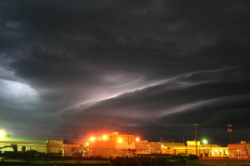 Guymon, OK: A thunderstorm approaches downtown Guymon, Oklahoma at night on Aug. 12, 2008