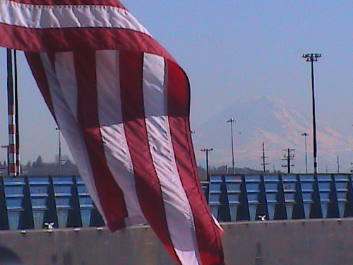 Seattle, WA: Mount Ranier with Old Glory flying from back of cruise boat