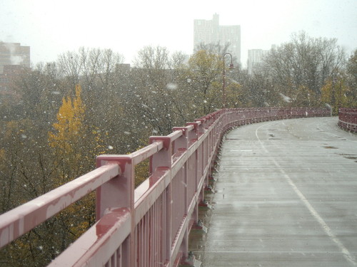 Minneapolis, MN: Snow falling over the old rail 14 bridge
