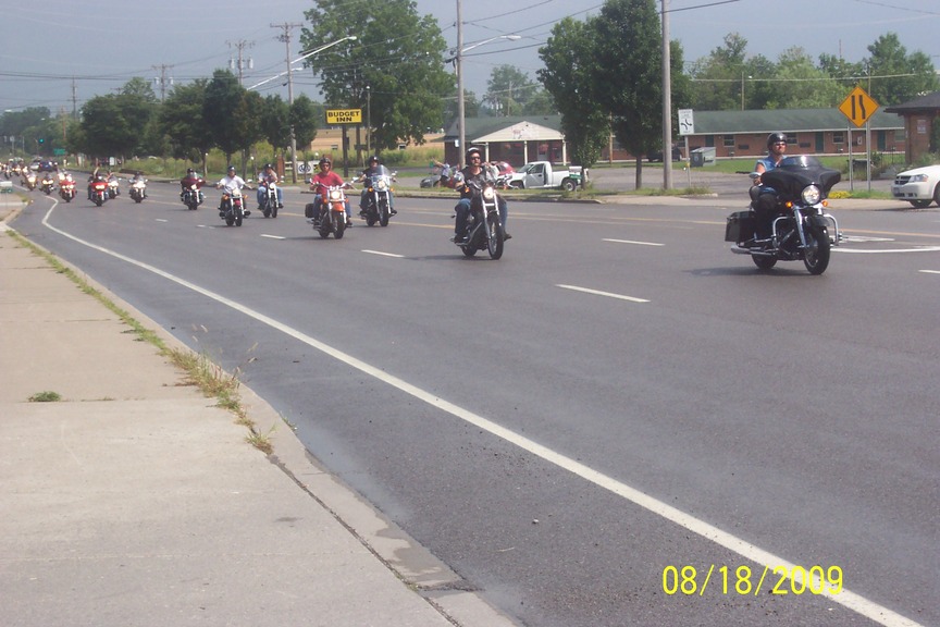 Farmington, NY: The Vietnam Moving wall passing through Farmington escorted by motorcycles and police. A picture of the escorts and a picture of the trailer which carried the wall. There were aprox 200 motorcycles it was a tribute to the VETS.