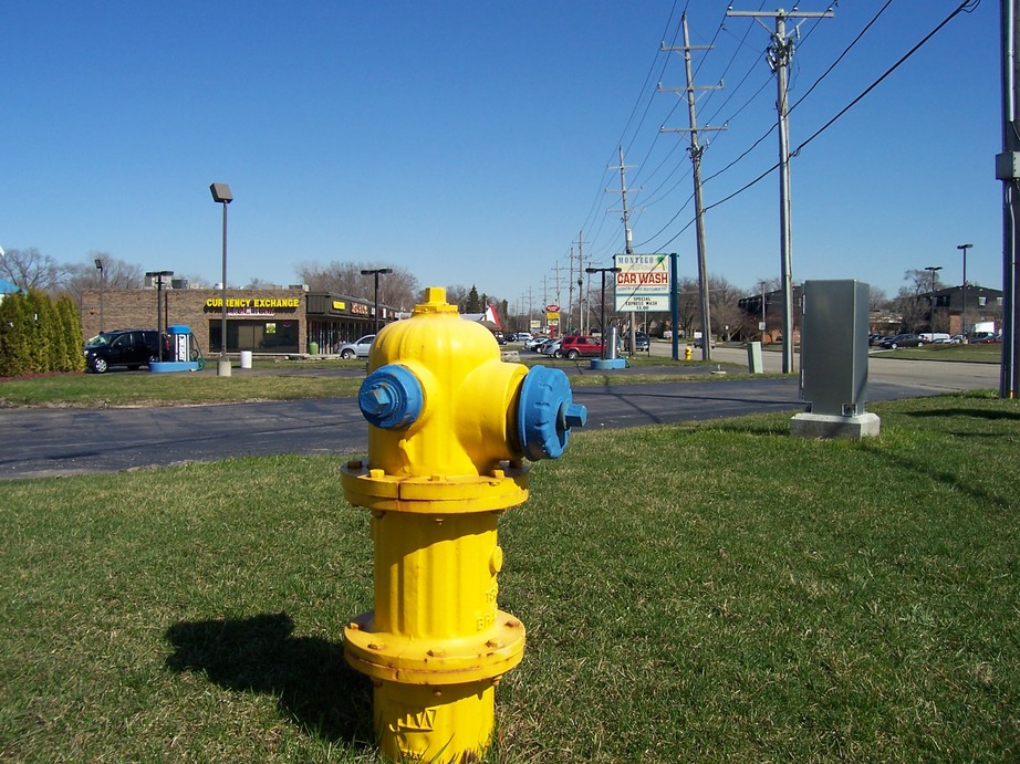 Tinley Park, IL : Fire hydrant in foreground, strip mall and red light 