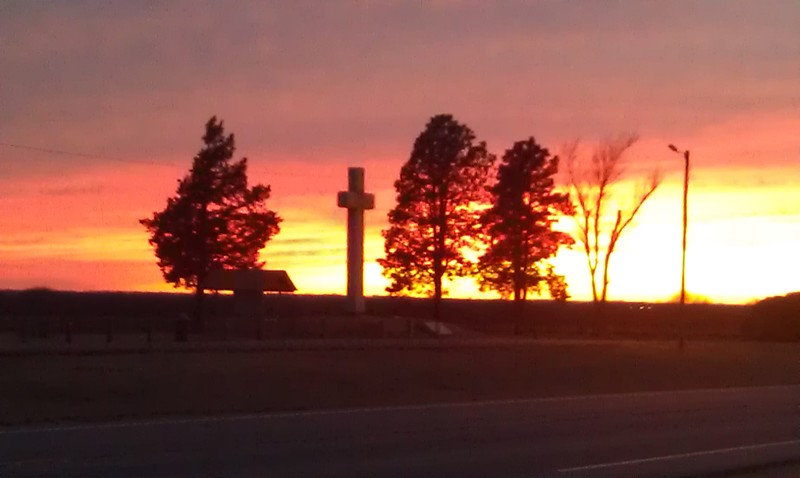 Lyons, KS: The beautiful sunset leaving Lyons west, with the cross in the forground.