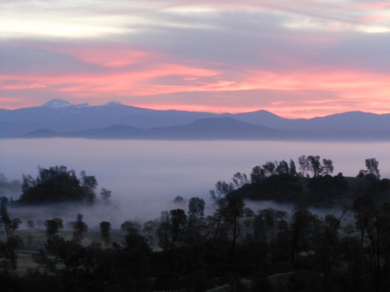 Cottonwood, CA: Lassen Peak and southern Cascades behind foggy Sacramento Valleyat sunrise