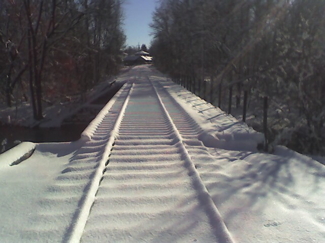 Mount Pleasant, MI: Snow covered railroad tracks that intersect the walkway connecting the city parks. (January 2006)