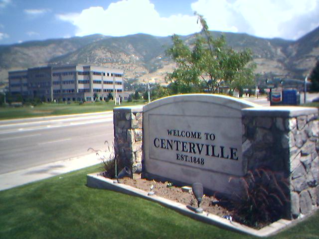 Centerville, UT: This sign, located just off I-15, welcomes visitors to Centerville. In the distance lies the Centerville Business Park - the centerpiece of the Centerville Marketplace.