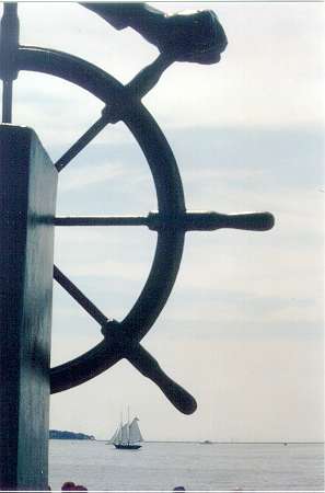 Gloucester, MA : Man At The Wheel Monument and schooner in Background