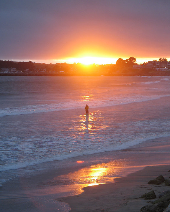 Half Moon Bay, CA: HMB Sunset with Pillar Point in the background and fisherman in the middle