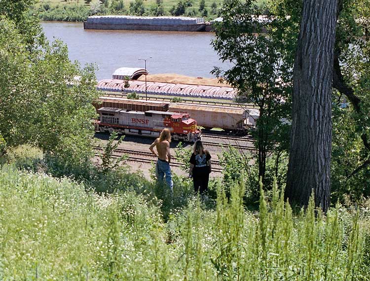 St. Paul, MN: A young couple at Dayton Bluff, St. Paul, MN watching the trains and river action