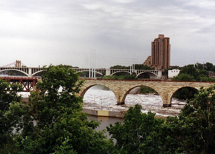 Minneapolis, MN: famed landmark James J. Hill Arch Bridge over the Mississippi River at near flood stage