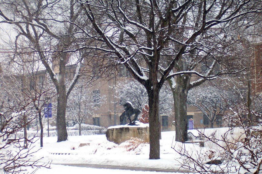 Winona, MN: A statue on the Winona State University campus during a beautiful March snow