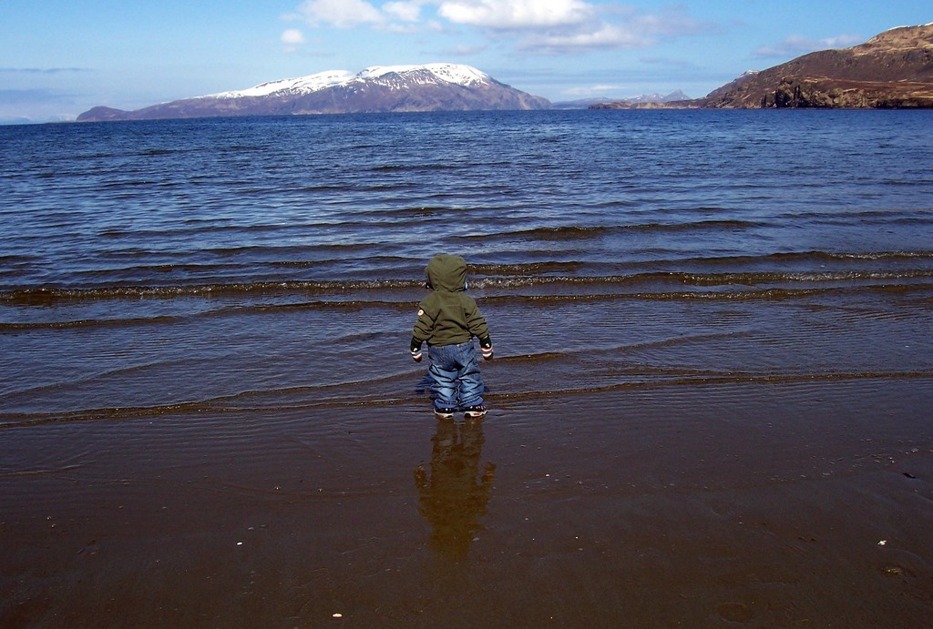 Sand Point, AK: The small island of Popof has some fantastic views. This is a child looking out at the distant mountains. Sand Dollar Beach is a must see in Sand Point, Alaska.
