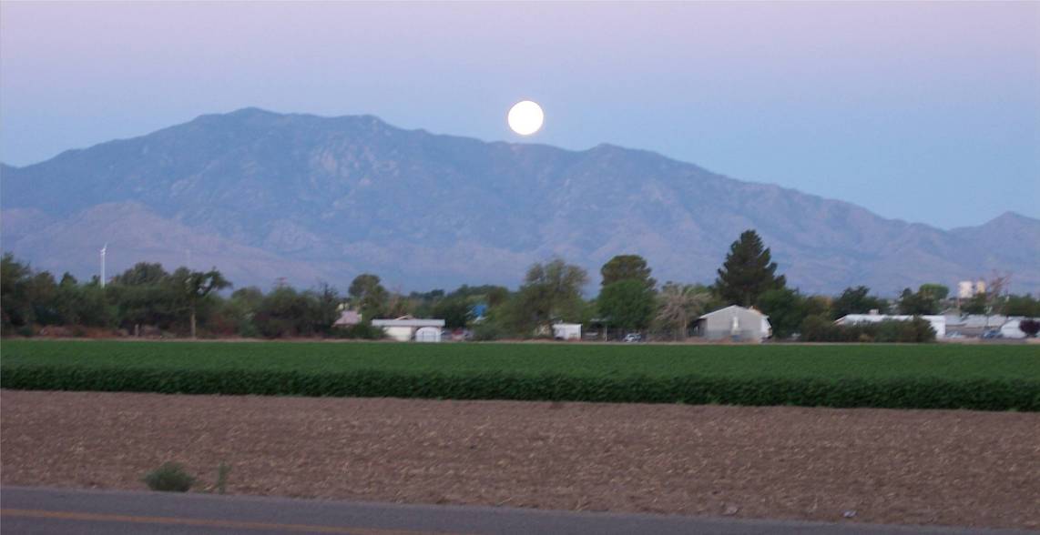 Pima, AZ: Full moon setting in the early morning behind Mount Graham