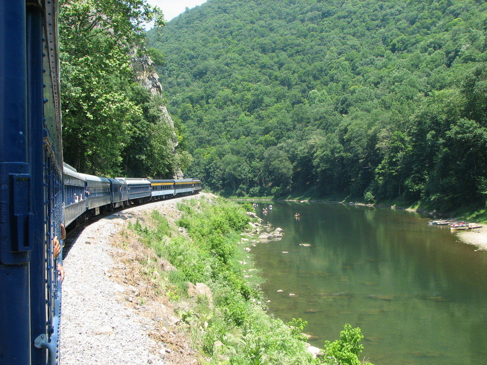 Romney, WV: The Potomac Eagle rounds the curve while families enjoy the trough Romney West Virginia July 2006