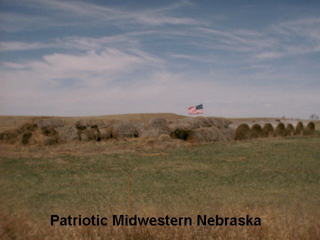 Merna, NE: Patriotic Midwest showing the American Flag in hay bales along the highway.