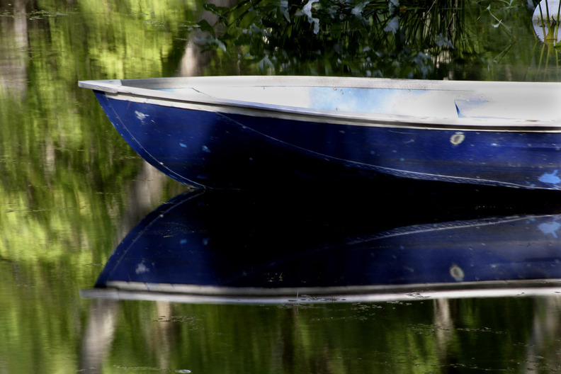 Lake Luzerne, NY A row boat and it's reflection doced along the lakeside photo, picture, image