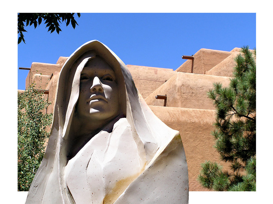 Santa Fe, NM: One of many beautiful sculptures with adobe style building.