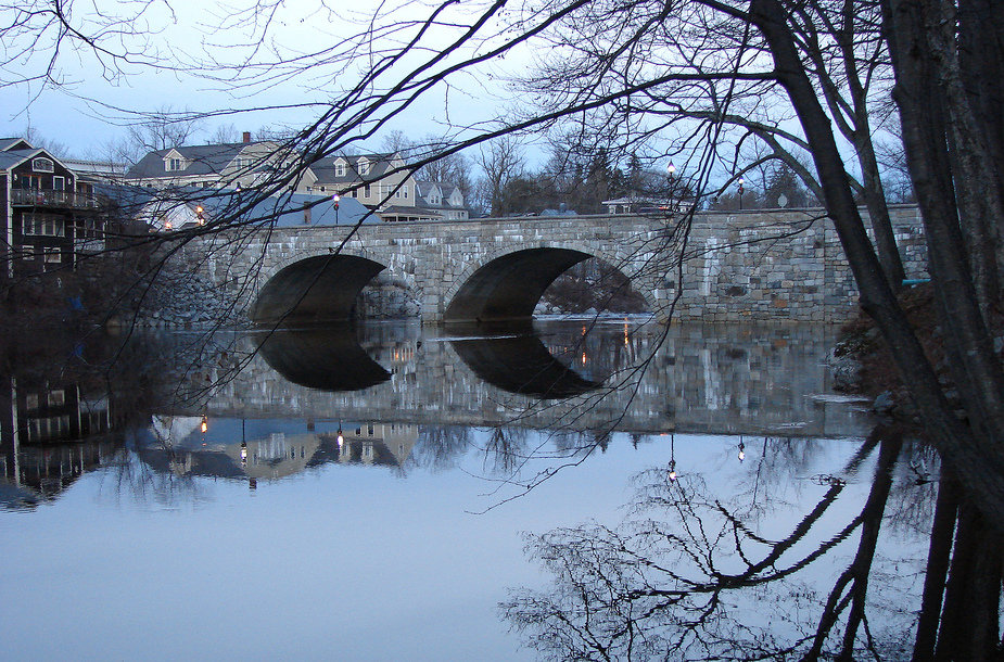 Henniker, NH: Early evening shot of Twin Stone Arch Bridge over Contoocook River in Henniker, N.H., from campus of New England College