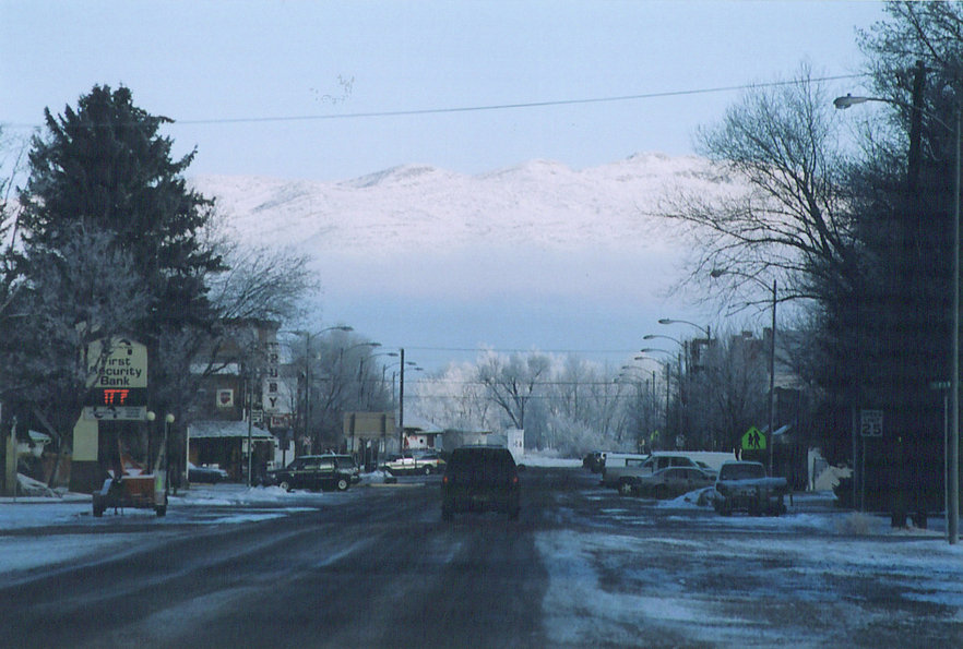 Three Forks, MT: Three Forks Main Street with snowy hills beyond