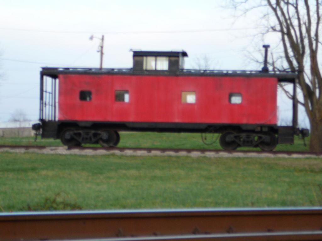 Sellersburg, IN: Red caboose along rail road tracks Sellersburg IN