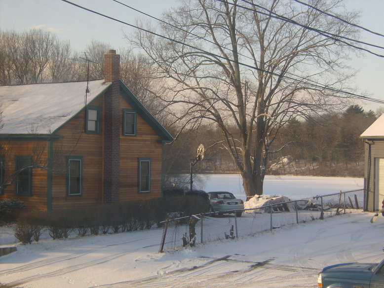 Pascoag, RI: This is a picture of this past winter of my neighbors house and lake across the street, it looks so beautiful over there when it snows.It is almost likes its surreal when you look over there especially when it snows out. This photo was taken on south main st. in pascoag, ri.