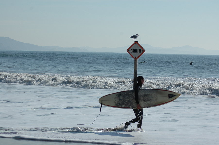 Bolinas, CA: surfer on the beach in Bolinas