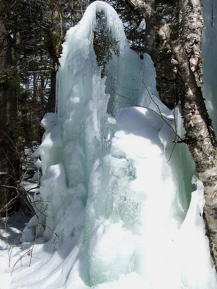 Sorrento, ME: giant icicle formed by a roadside pipe spraying upwards