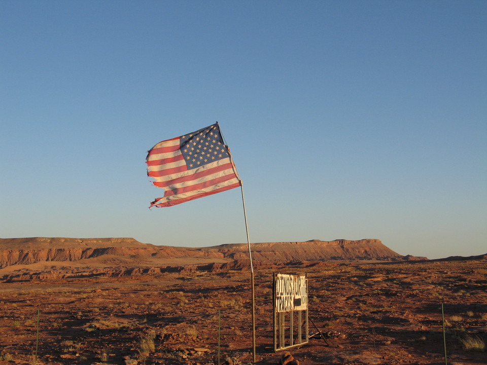 Tuba City, AZ: An old flag waves near Dinosaur tracks