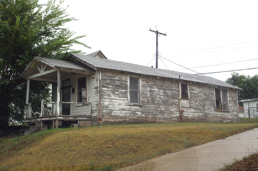 Pampa, TX: HISTORIC "SHOTGUN" HOUSE, typical of post-WW2 residences built for employees of oil companies, was originally located in an employee "camp" alongside a refinery or plant. It is now located across the street from Central Park. The nearby town of Borger has many more of these.