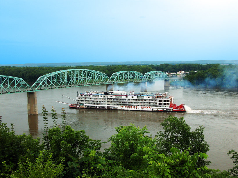Louisiana, MO: Mississippi Riverboat the Mississippi Queen passes through Louisiana, Missouri, lowering its smoke stacks to clear under the Champ Clark Bridge