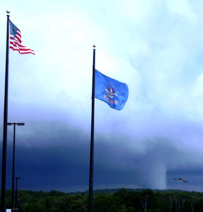 Belcourt, ND: An American bald eagle flies towards the flags as a tornado rips through our area...a sure sign that we wer truly being watched over!