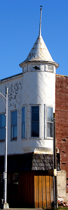 Callender, IA: Five, four, three, two, one, CALLENDER!! Oh wait, that's not a missile! It's a tin-covered, funnel-roofed turret window. Put into place well over 100-years ago, the battery of windows still looks over Callender's Main Street. ~ If only it could speak.