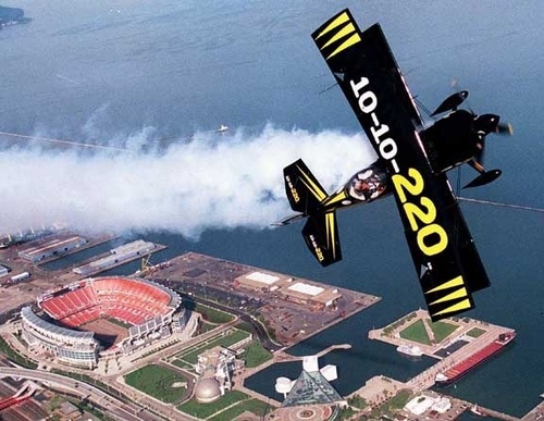 Cleveland, OH: An acrobatic plane over Cleveland stadium.