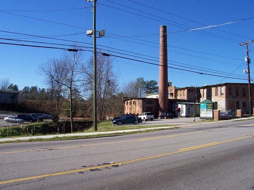 Lexington, SC: In this shot can be seen Lexington's Old Mill, with the earthen Mill Pond dam (background) on Twelve Mile Creek (left of center). The old mill has been converted from the main driver of Lexington's old time economy into a number of business, including a Pizza Buffet. Taken January on 9th, 2009.
