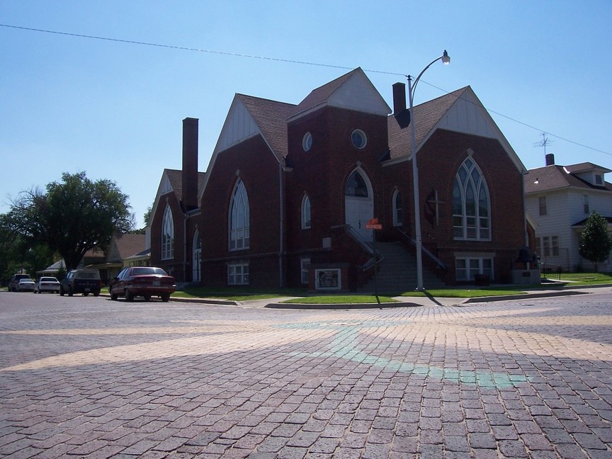 Ellis, KS: First Methodist Church Foreground: Brick street with sunflower painted in middle. There are many of these in Ellis