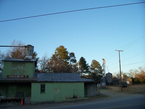 Swansea, SC: One of Swansea Milling Company's buildings on the corner of W Second Street and N Spring Street in Swansea, South Carolina. The mill is located one block to the west of the train tracks. The silos in the background likely belong to them as well.