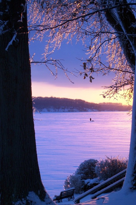 Sodus Point, NY: At dawn the first ice fisherman ventures out onto Sodus Bay, in Sodus Point NY