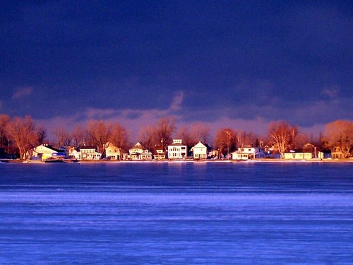 Sodus Point, NY: Setting sun lights up the houses on "The Loop" in the village of Sodus Bay, while early winter storms threaten the region.